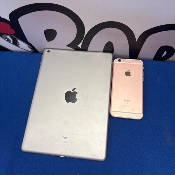 Silver Apple iPad and gold iPhone presented as a lot.