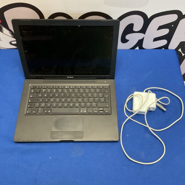 Silver Apple MacBook laptop with charger on blue background.