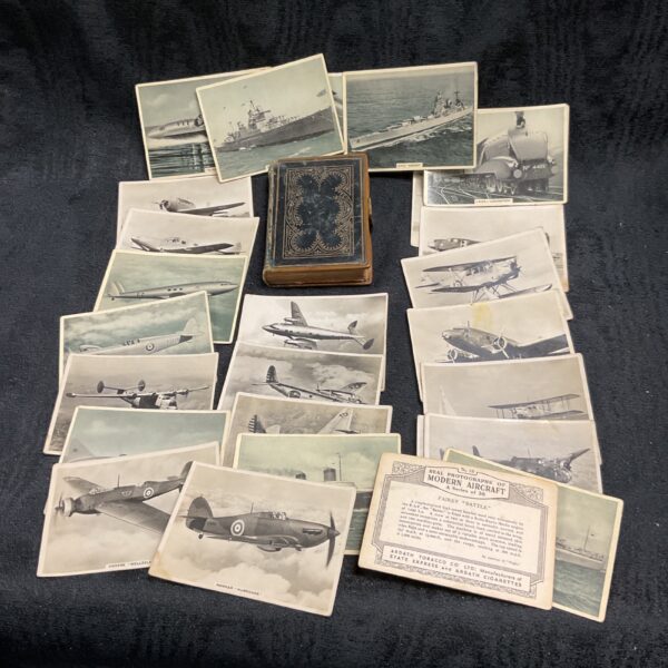 Vintage Ardath cigarette cards and a soldiers bible, wartime collectibles.