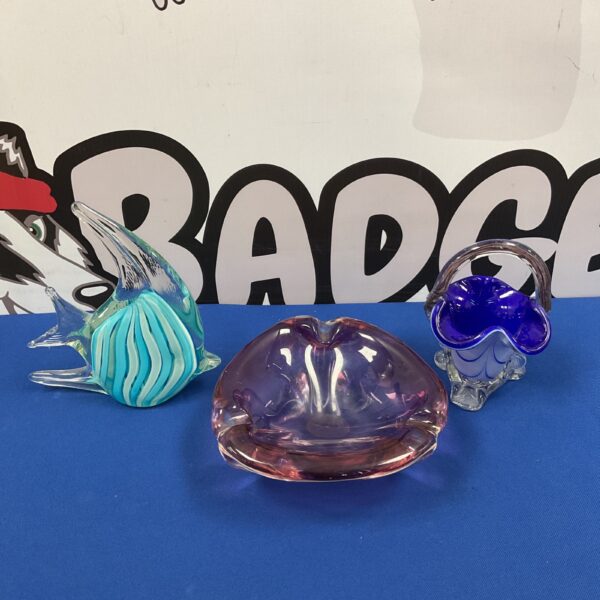Vibrant art glass bowl with a sculpted fish design.