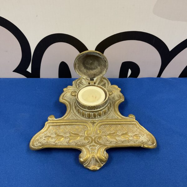 Antique Art Nouveau brass pen stand with inkwell and ornate detailing.