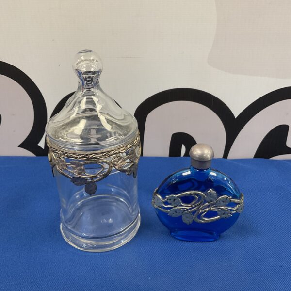 Delicate Art Nouveau scent bottle and lidded jar with white metal filigree.