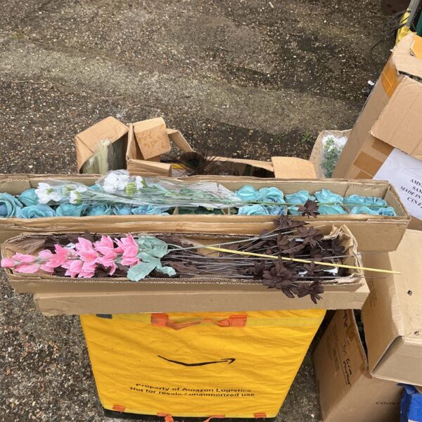 Bulk lot of colourful artificial flowers for crafting.