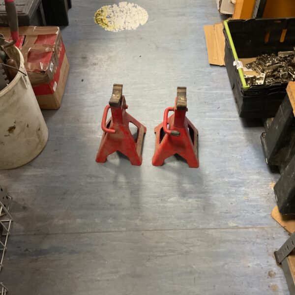 Pair of used automotive axle stands for vehicle repair.