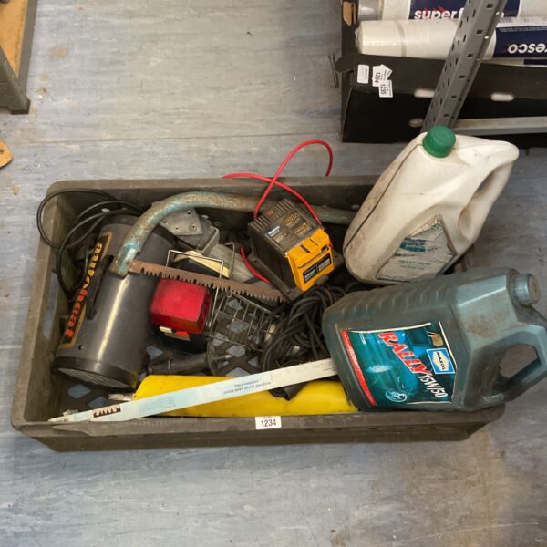 Mixed automotive and tool lot with charger, oil, and saw blades.