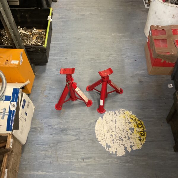 Pair of red 2 tonne folding axle stands for car repair.