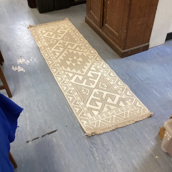 Woven runner rug with geometric pattern, ideal for hallways.