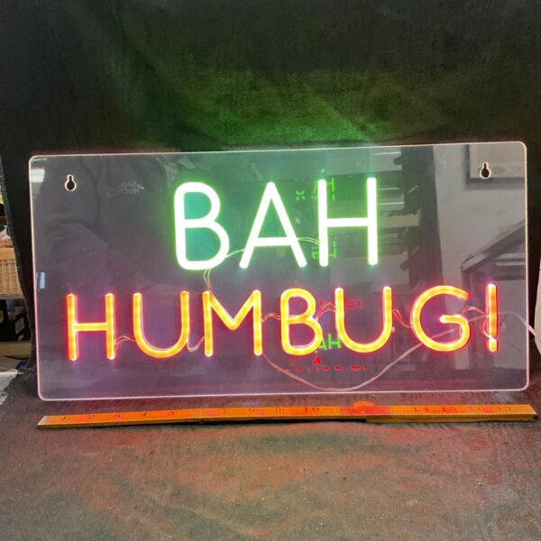 Front view of a vibrant "Bah Humbug" LED sign for Christmas decor.