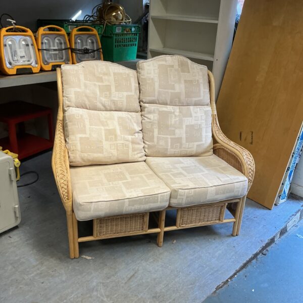 Vintage bamboo conservatory chair with patterned seat cushions.