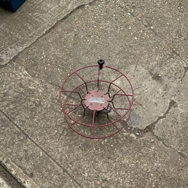 Vintage metal Basel Reel for garden hose storage.