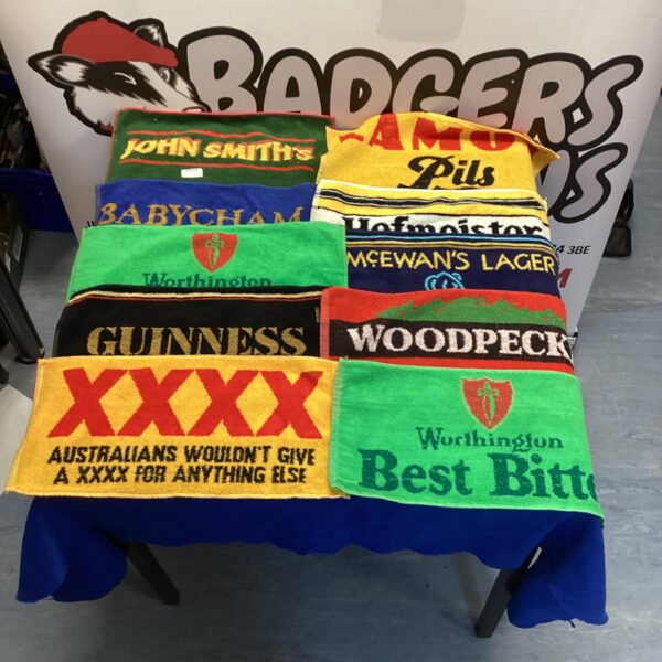 Vintage beer mats collection featuring Guinness and other brands.