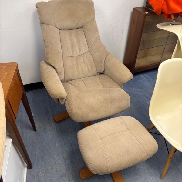 Beige lounge chair with matching footstool for comfortable relaxation.