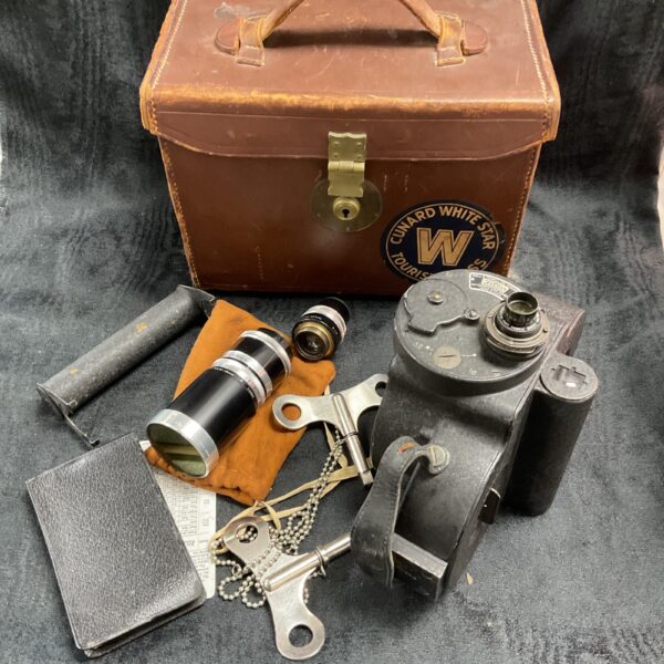 Vintage Bell & Howell cine camera in leather case with Cunard stickers.