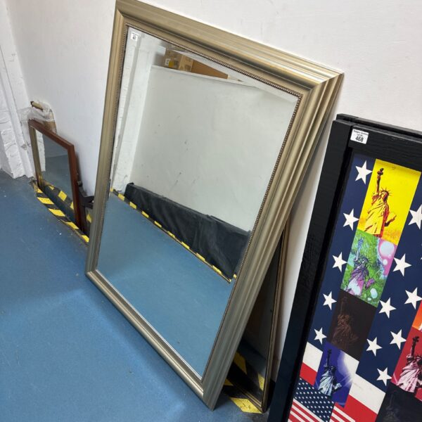 Large gilded bevelled edge mirror for wall decoration.