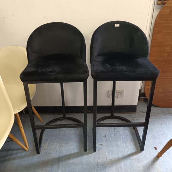 Pair of black fabric bar stools for kitchen or home bar.