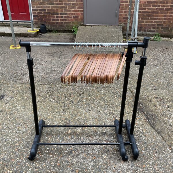Black metal clothes rail with hangers, ideal for garment storage.