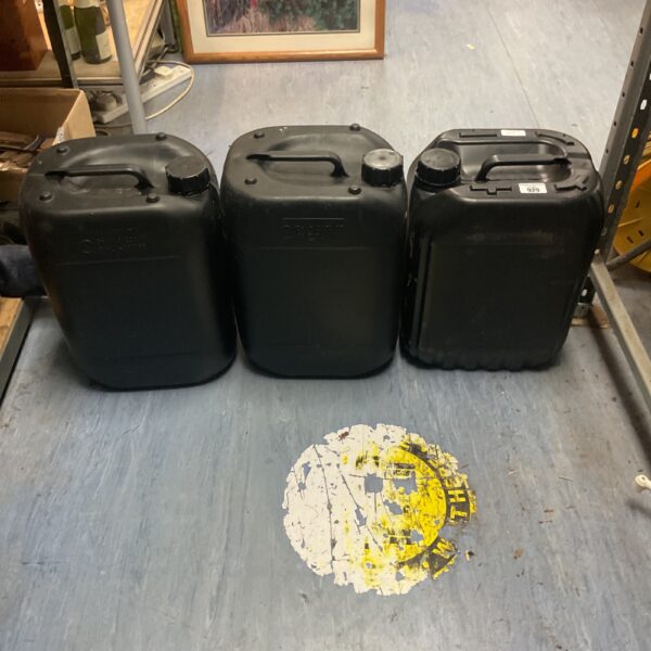 Set of three black plastic jerry cans for liquid storage.
