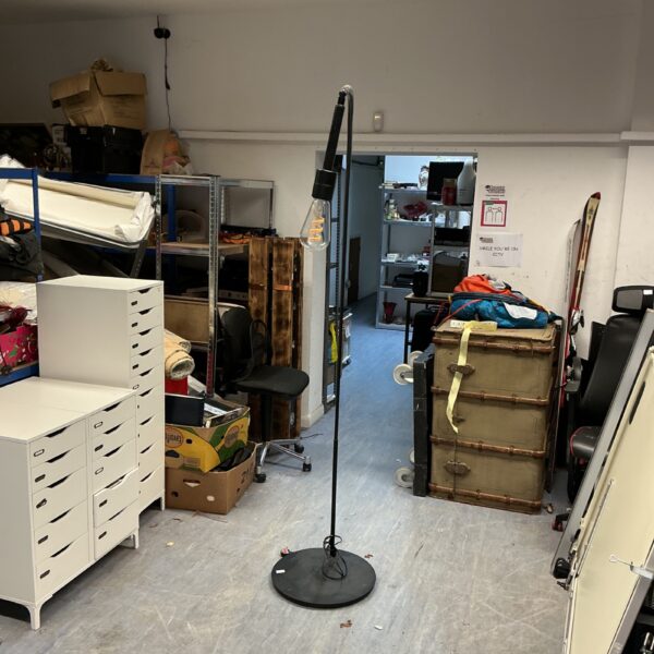 Black standard lamp in a room, adjustable studio lighting.