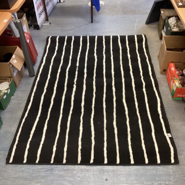 Black and white striped rug for home decor.