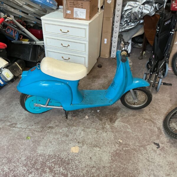 Vintage blue child’s electric scooter, a classic ride-on toy.