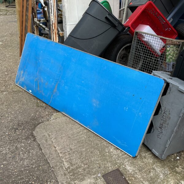Blue plastic folding table, six feet long, showing signs of wear.