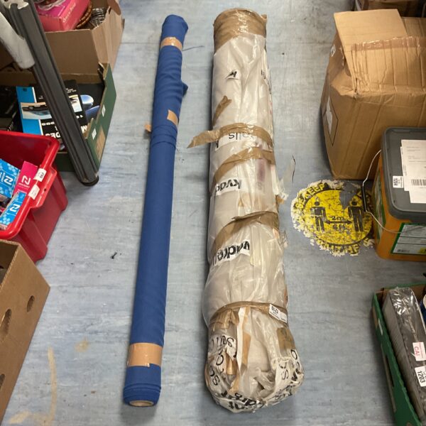Two rolls of blue upholstery fabric for crafting projects.