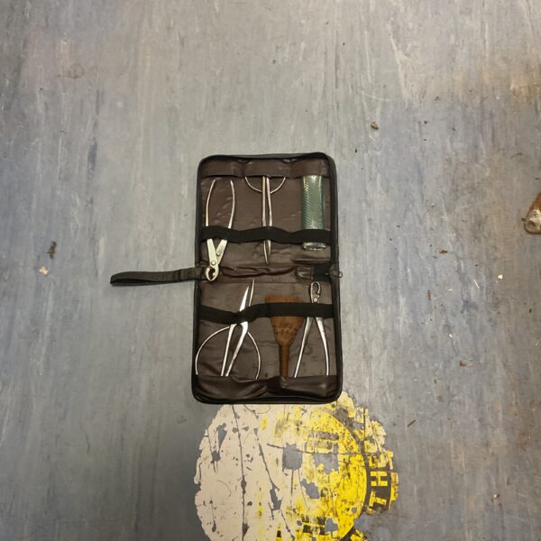 Black zipped case containing a bonsai tool kit with metal tools.