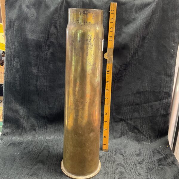 Vintage 1936 brass cannon shell, detailed front view.