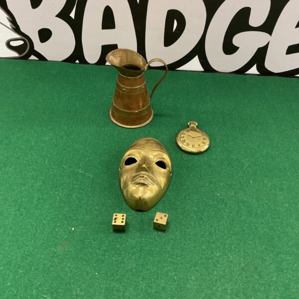 Vintage brass collectibles lot including vessel, dice, and mask.