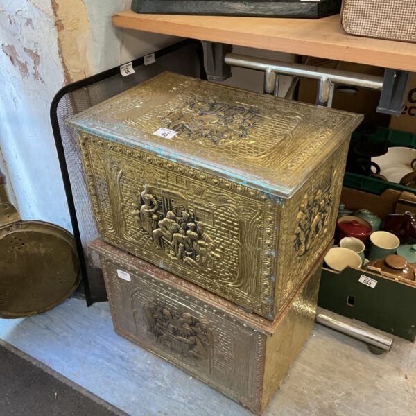 Vintage brass log box with detailed tavern scene relief carvings.