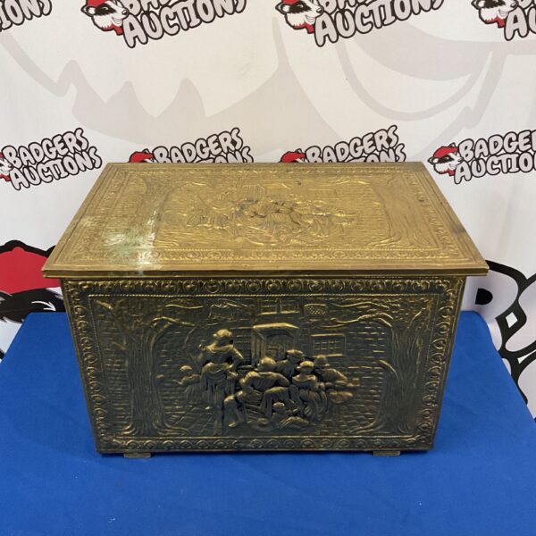 Antique brass log box with detailed tavern scene relief.
