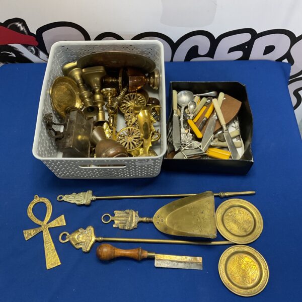 Tray of vintage brassware and cutlery including candlesticks and a copper plate.