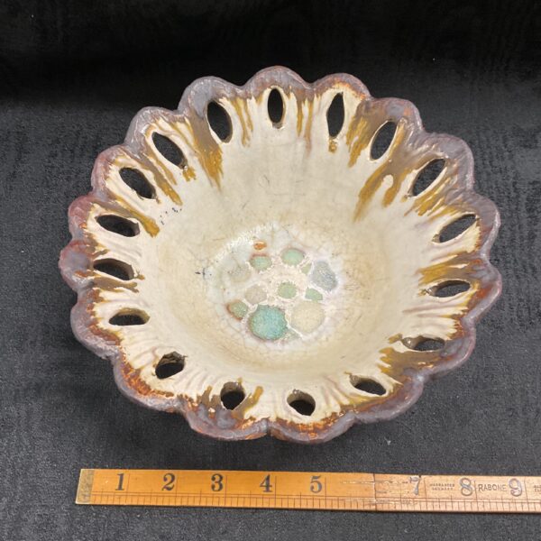 Front view of a textured Brenda Piper studio pottery bowl.