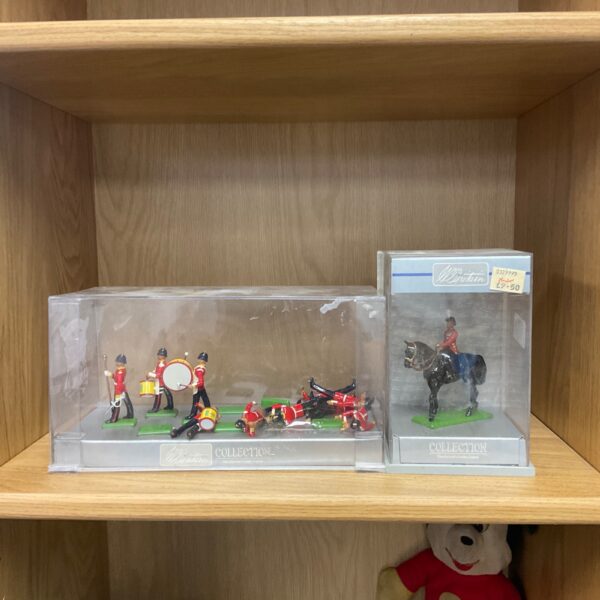 Vintage Britains metal figures depicting a band and soldier on horseback.