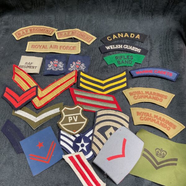 Collection of British military cloth badges including RAF and Royal Marines insignia.