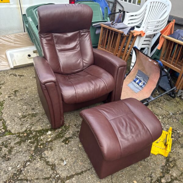 Brown leather reclining armchair with footstool for comfortable seating.