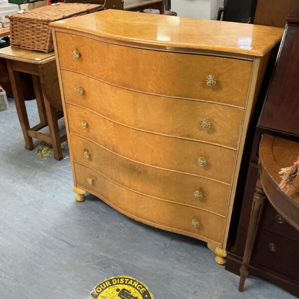 Antique bur walnut serpentine chest of drawers with brass pulls.