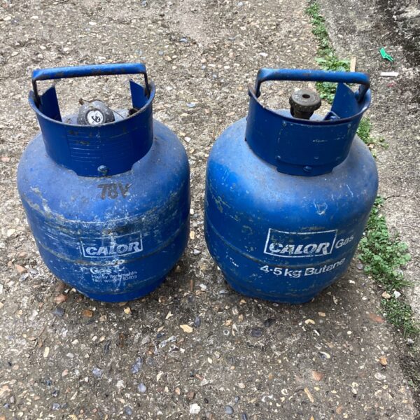 Two blue Calor Gas 4.5kg butane bottles for camping and outdoor use.