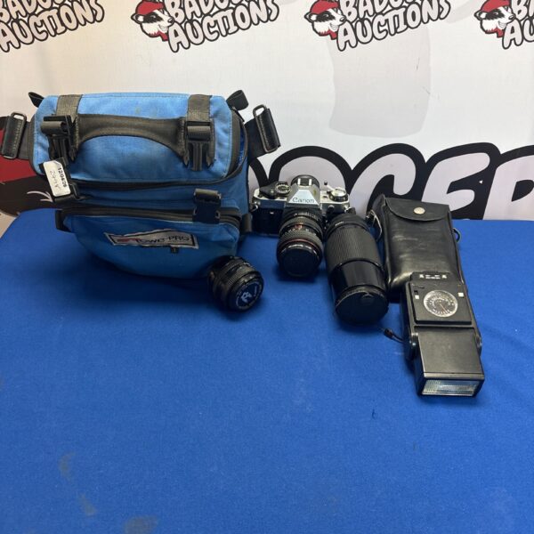 Vintage Canon AS-1 SLR camera kit with lenses and flash.