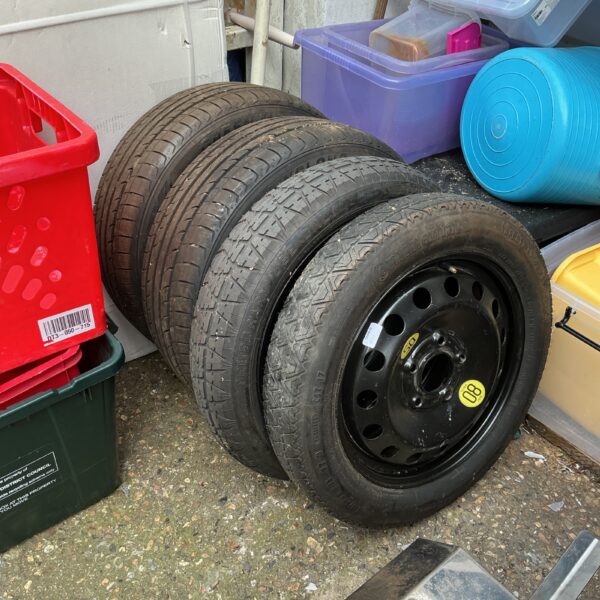 Lot of four used car wheels and tyres, including space savers.