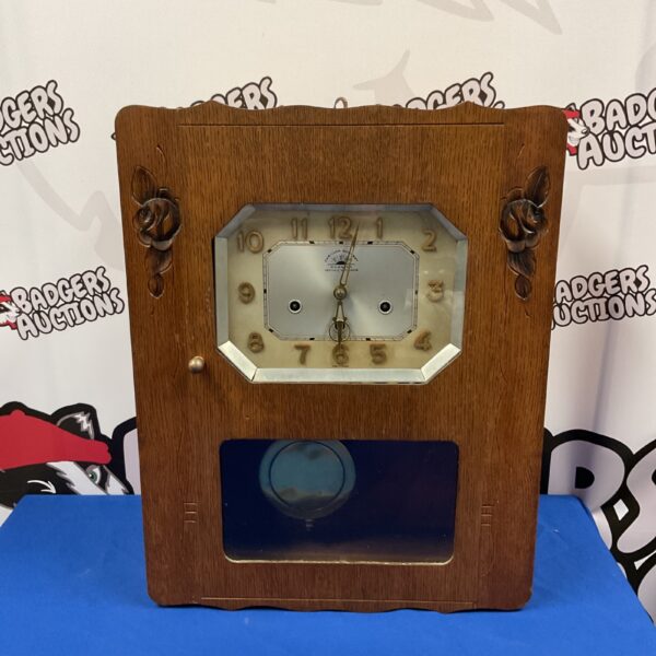 Front view of a vintage Carillon Romanet Morbier clock.
