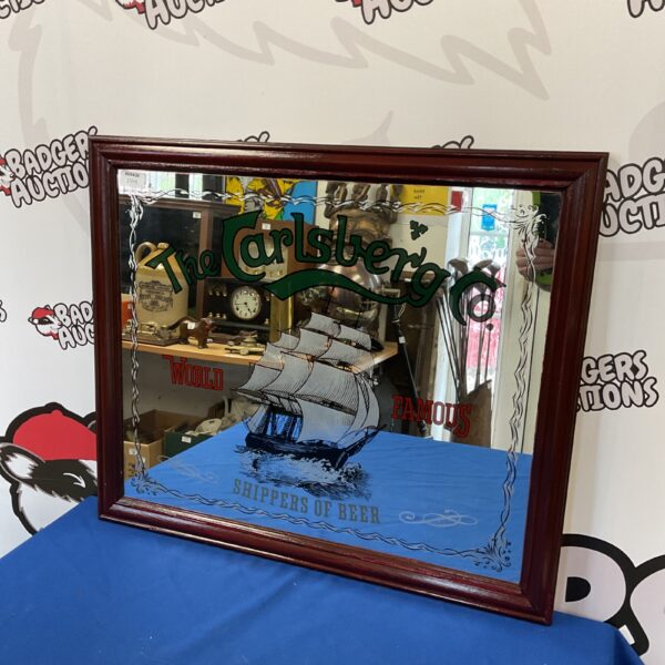 Vintage Carlsberg pub mirror with nautical scene and "World Famous Shippers of Beer" slogan.