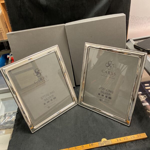Two Carrs sterling silver picture frames in their original boxes.