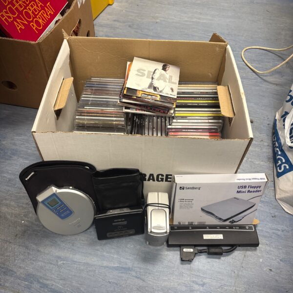 Vintage CD and cassette player lot with CDs and box.