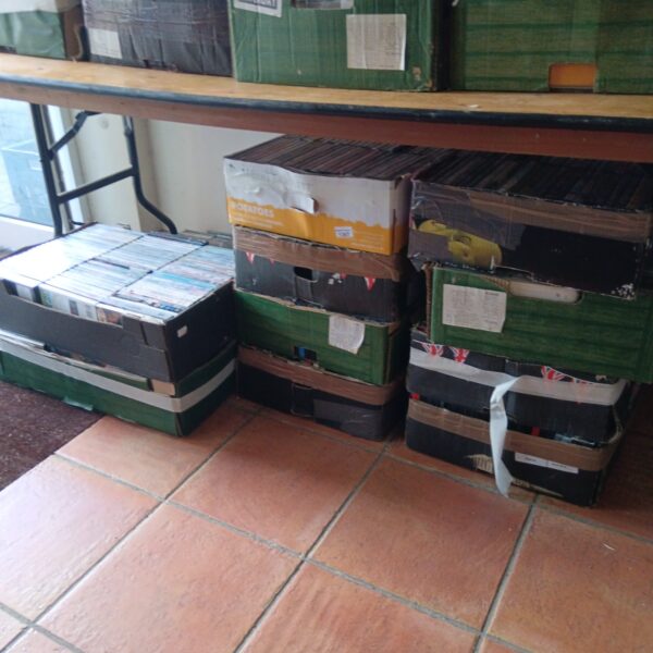 Stacked trays of CDs and DVDs in a bulk collection.