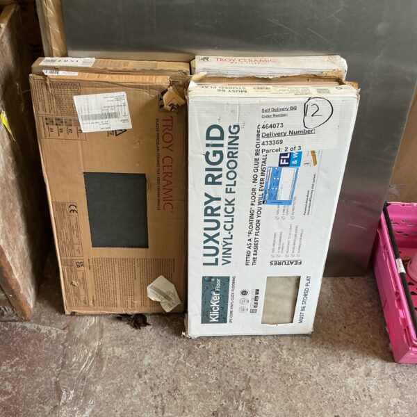 Stack of five boxes of mixed ceramic floor tiles.