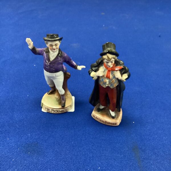 Vintage porcelain Charles Dickens figurine in Victorian attire.