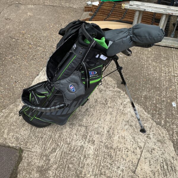 Black and red child’s golf bag with clubs visible.