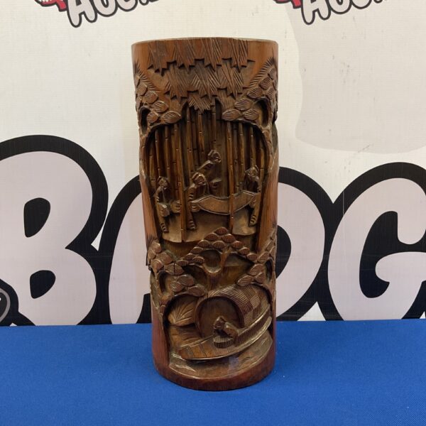 Intricately carved Chinese bamboo brush pot with landscape scene.