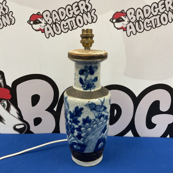 Antique Chinese blue and white porcelain vase lamp with floral designs.